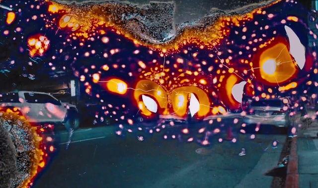 Video Reference: Automotive lighting, Orange, Asphalt, Paint, Font, Road surface, Tints and shades, Art, Electric blue, Event