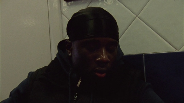 Video Reference: Outerwear, Cap, Eyewear, Grey, Beard, Personal protective equipment, Darkness, Audio equipment, Baseball cap, Facial hair