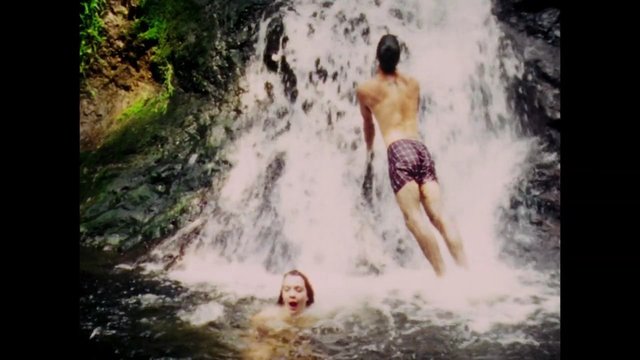 Video Reference: waterfall, swimming, pool, nature, outdoors, adventure, cascading water, person, summer, travel, recreation, rocky, forest, wet, action
