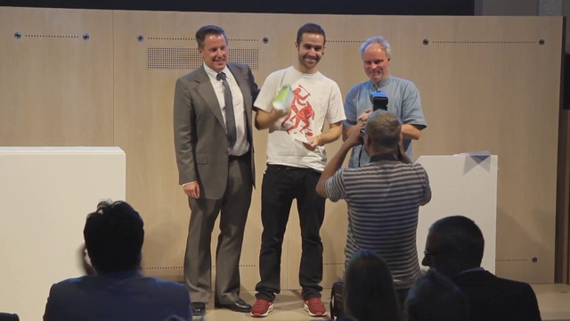 Video Reference: Smile, Jeans, Shirt, T-shirt, Chair, Adaptation, Microphone, Event, Stage equipment, Technology