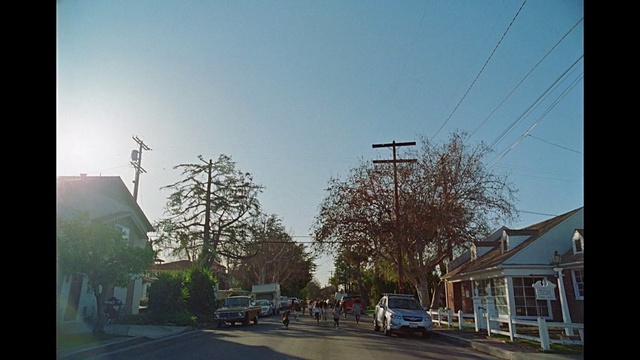 Video Reference: Sky, Car, Building, Plant, Wheel, Infrastructure, Tree, Branch, Road surface, Asphalt