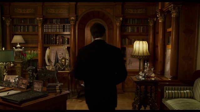 Video Reference: Picture frame, Interior design, Building, Table, Suit, Lamp, Shelf, Formal wear, Darkness, Event