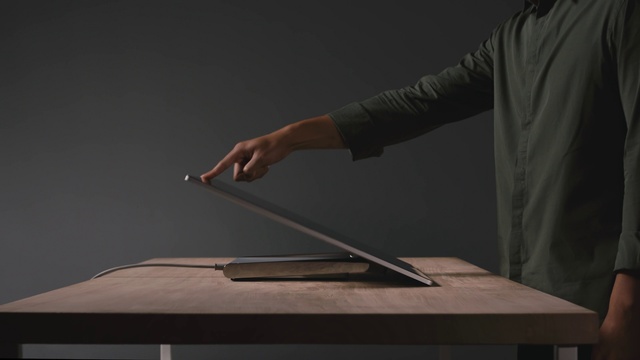 Video Reference: Hand, Arm, Table, Sleeve, Gesture, Desk, Wood, Office supplies, Netbook, Automotive design