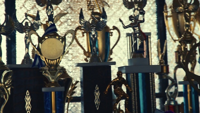 Video Reference: Font, Wood, Tints and shades, Metal, Art, Religious item, Symbol, Visual arts, Light fixture, Shadow