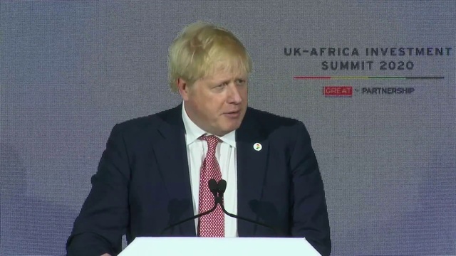 Video Reference: Microphone, Outerwear, Coat, Dress shirt, Tie, Podium, Suit, Spokesperson, Public address system, Collar