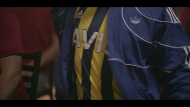 Video Reference: Jersey, Sleeve, Flag, Gesture, Collar, Sportswear, Font, Tints and shades, Electric blue, T-shirt