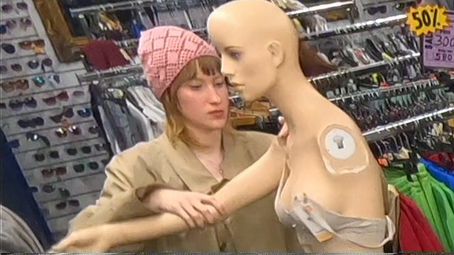 Video Reference: store, woman, mannequin, clothing, retail, sunglasses, shopping, fashion, accessories, indoor, display, rack, sale sign, adjusting