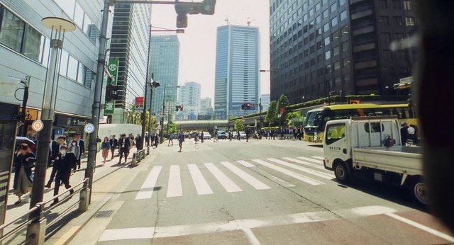 Video Reference: Building, Tire, Skyscraper, Vehicle, Infrastructure, Road surface, Wheel, Tower block, Thoroughfare, Asphalt