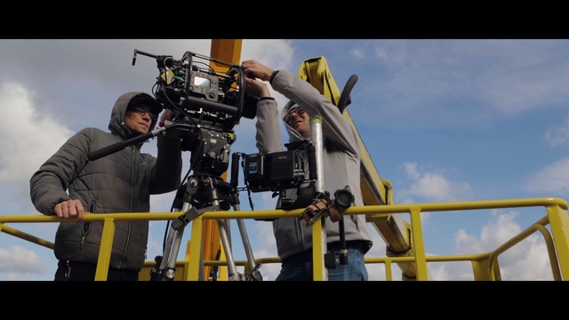 Video Reference: Cloud, Sky, Videographer, Tripod, Yellow, Film crew, Television crew, Cinematographer, Documentary, Engineering