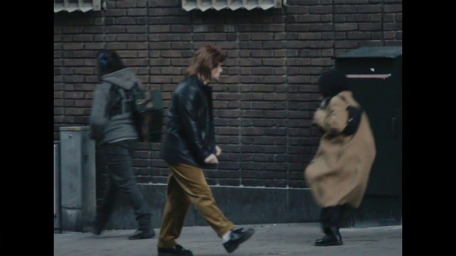 Video Reference: Footwear, Shoe, Leg, Human, Standing, Gesture, Grey, Luggage and bags, Road surface, Bag