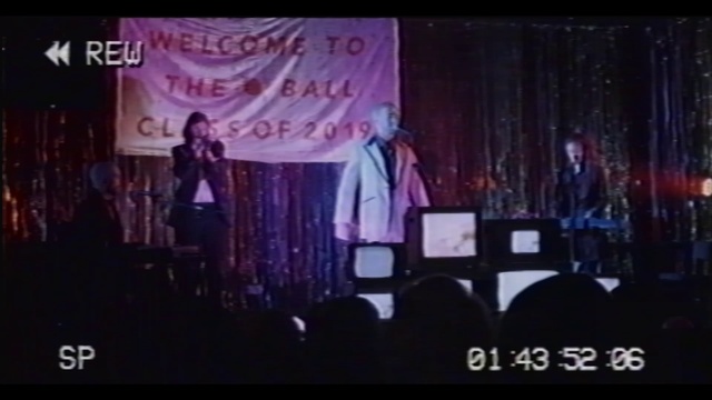 Video Reference: Purple, Entertainment, Performing arts, Curtain, Font, Magenta, Music artist, Display device, Event, Music