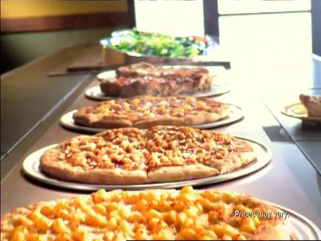Video Reference: pizza, buffet, food, restaurant, trays, counter, meal, cheese, salad, fast food, dining, catering, indoor, close-up