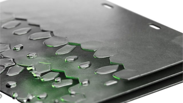 Video Reference: water droplets, macro, close-up, abstract, black surface, texture, green highlights, studio lighting, reflection, wet surface, minimal, geometric, surface detail