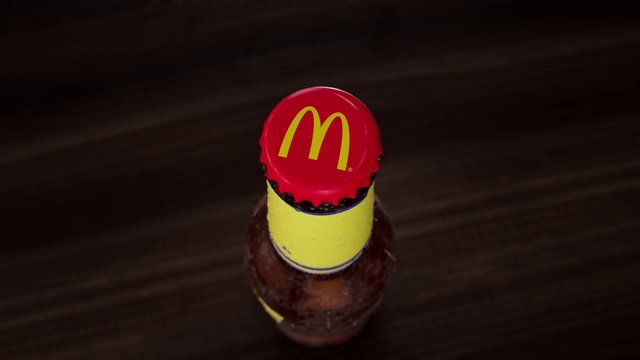 Video Reference: Food, Bottle cap, Drink, Sweetness, Automotive design, Fashion accessory, Carmine, Confectionery, Logo, Ingredient