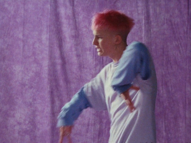 Video Reference: Purple, Sleeve, Gesture, Happy, Flash photography, Magenta, T-shirt, Entertainment, Electric blue, Fun