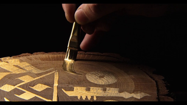 Video Reference: Wood, Art, Sleeve, Font, Tints and shades, Automotive design, Wrist, Darkness, Flooring, Pattern