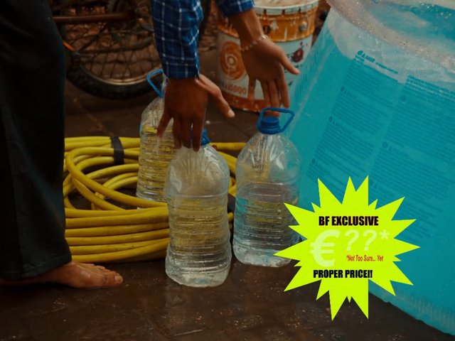 Video Reference: plastic jugs, water containers, hose, wet floor, hands, container, indoor, work scene, promotion graphic, text overlay, blue container, coiled hose, utility, close-up