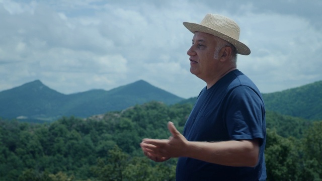 Video Reference: Sky, Cloud, Hat, Sun hat, Mountain, Grass, Tree, Travel, Landscape, Grassland