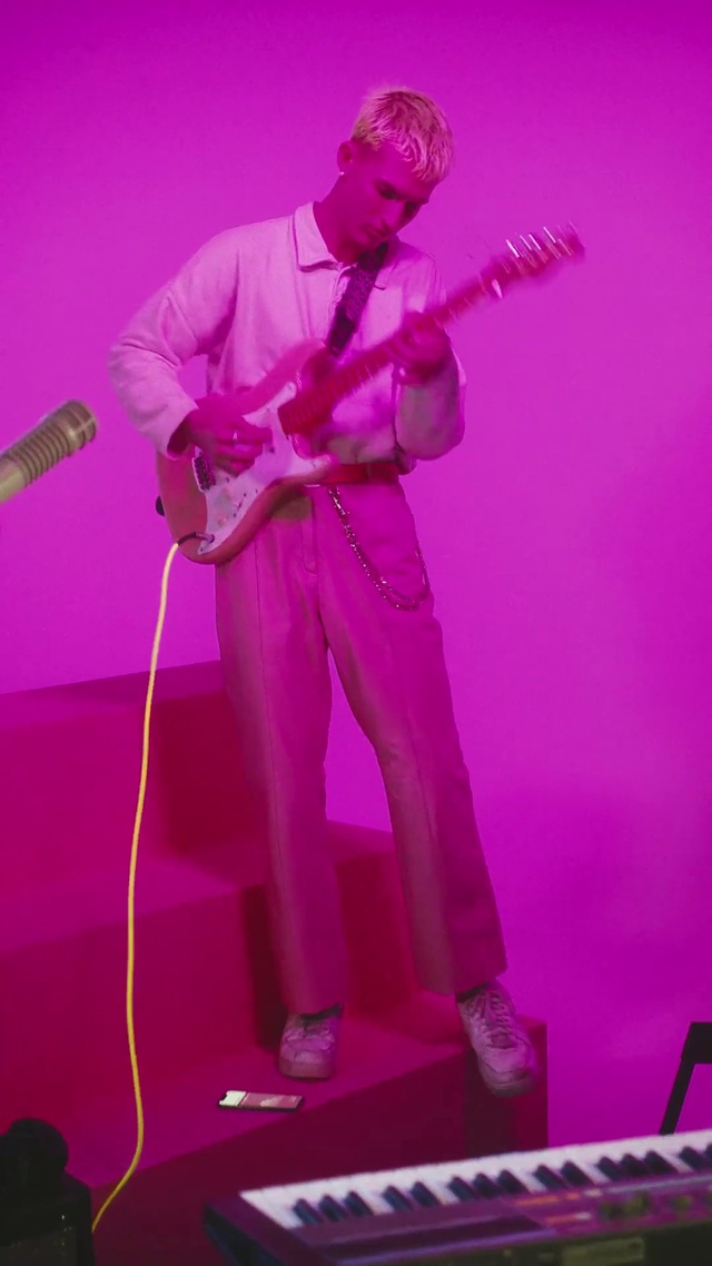 Video Reference: Microphone, Musical instrument, Arm, Musician, Guitar, Purple, Light, Public address system, Music artist, Human body