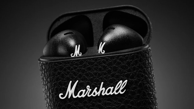 Video Reference: wireless earbuds, charging case, black, product shot, close-up, audio, earphones, tech gadget, portable case, textured surface, minimal background, consumer electronics