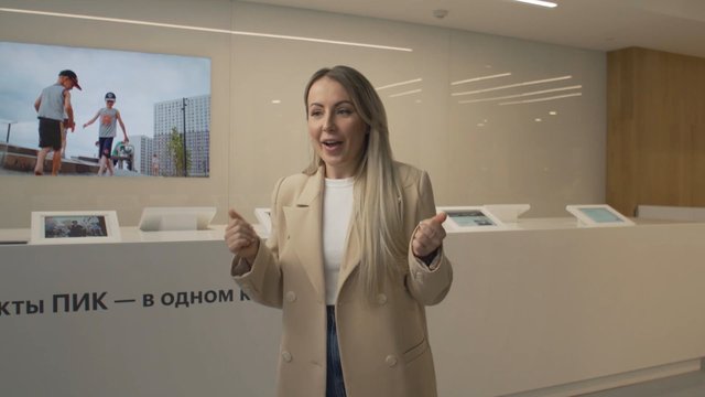 Video Reference: woman, office, showroom, presentation, indoor, business, reception, gesturing, modern interior, blazer, speaker, real estate, lobby, interview, corporate