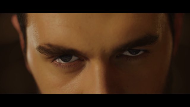 Video Reference: close-up, eyes, face, man, serious, intense, portrait, dramatic lighting, warm tone, cinematic, brow, gaze