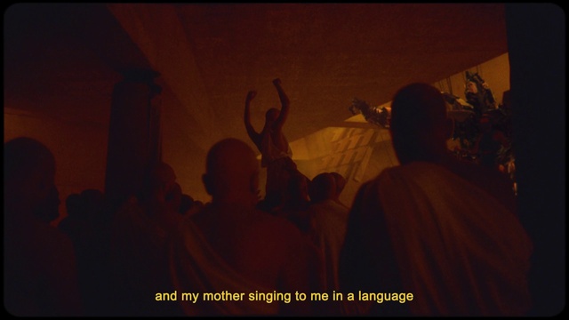 Video Reference: Font, Hat, Event, Art, Monk, T-shirt, Darkness, Religious item, Guru, Crowd