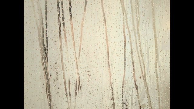 Video Reference: water droplets, wet glass, streaks, texture, abstract, close-up, surface, rain, moisture, translucent, light background, pattern