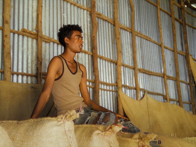 Video Reference: Human, Temple, Wood, Leisure, Vest, Sleeveless shirt, T-shirt, Elbow, Room, Sitting