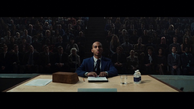 Video Reference: Table, Microphone, Coat, Suit, Chair, Desk, Spokesperson, Event, Public speaking, Tie